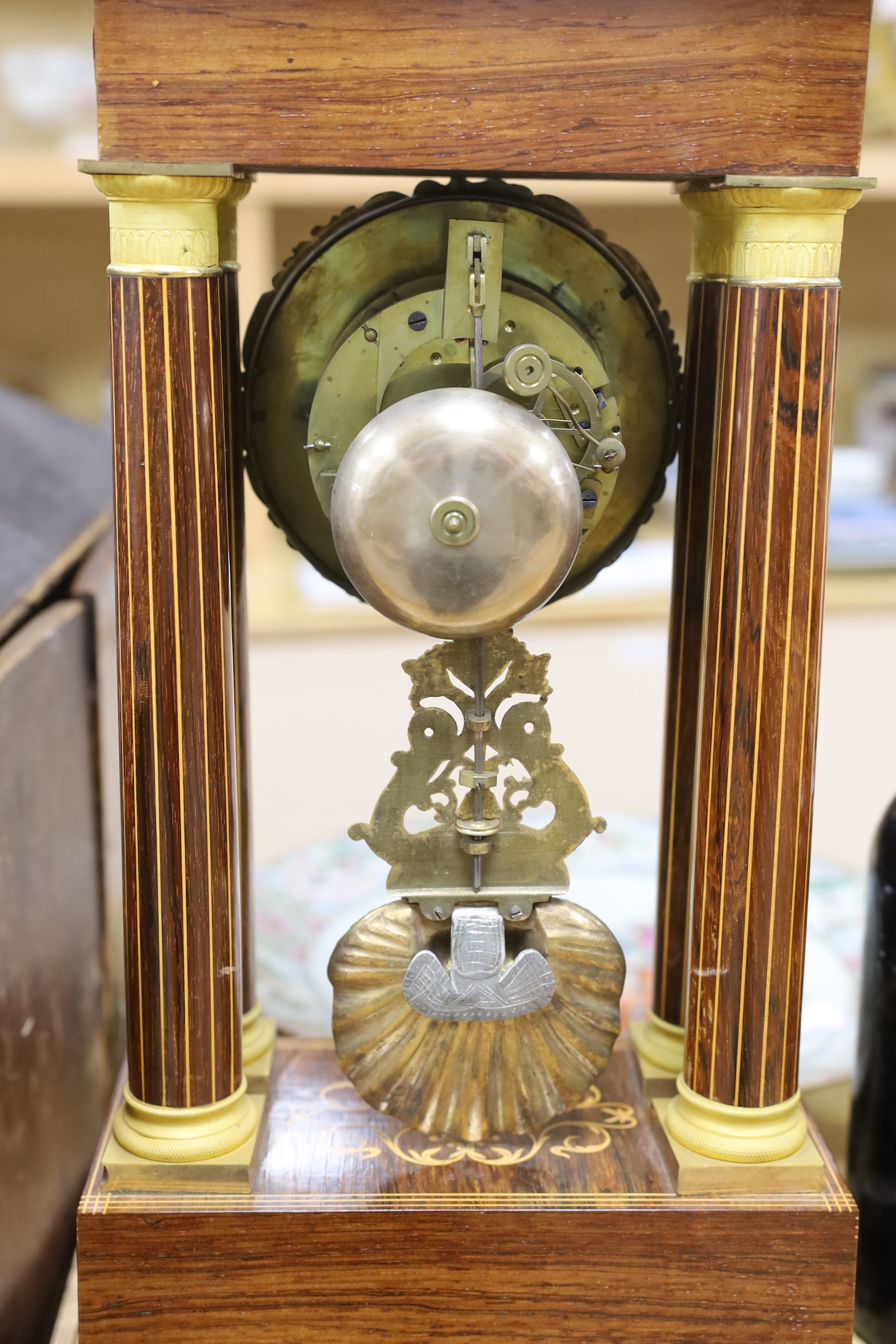 A French Charles X rosewood and marquetry portico clock, 25.5cm wide, 52cm high